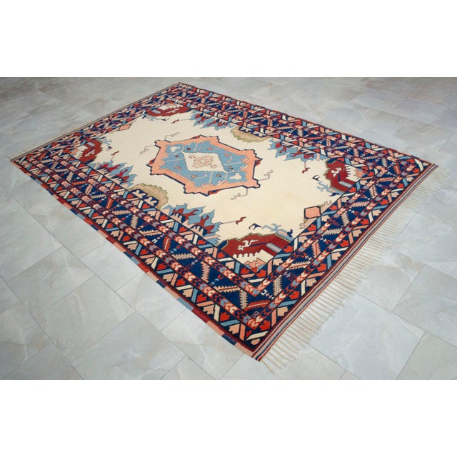 Crafted in the famed weaving workshops of Oushak in Aegean Anatolia during the 1970s, this authentic hand-knotted rug...