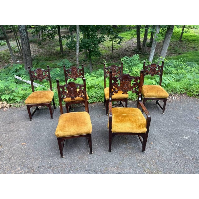 Antique Renaissance Revival Lion Northwind Carved Dining Chairs It features carved scrollwork back, lion/northwind carved...