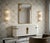 A captivating transparent white hue defines this Murano glass wall lamp, featuring a captivating, elongated design and a...