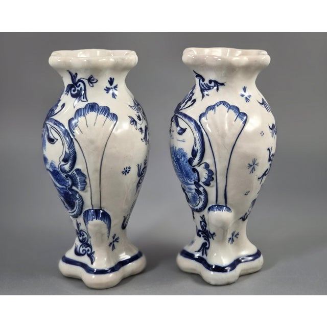 The vases form an original matched pair, with identical moulded baluster bodies, four-lobed rims and bases, prominent...