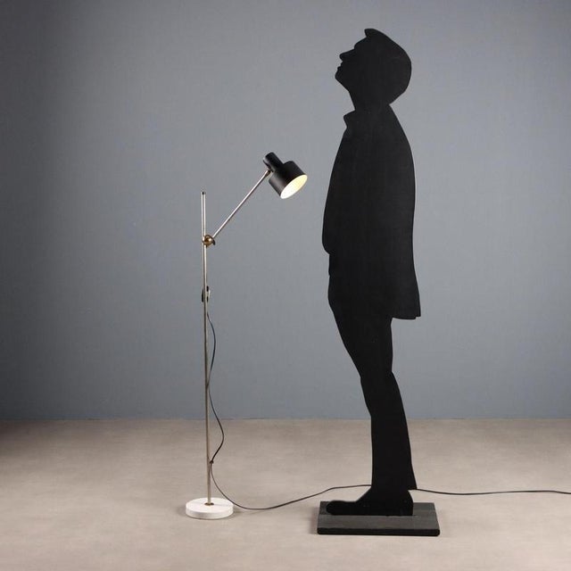 Vintage floor lamp made in Italy with a circular marble base, a metal stem with a height-adjustable arm that can be...