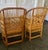 A striking pair of Brighton Pavilion style bamboo armchairs featuring gracefully arched backs, woven cane seats, and...