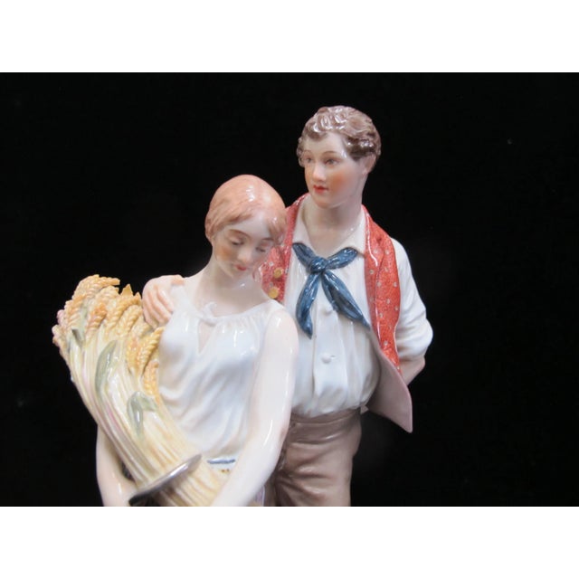 Antique porcelain Meissen figurine of peasant couple at harvest, finely hand painted in polychrome and glazed with gold...