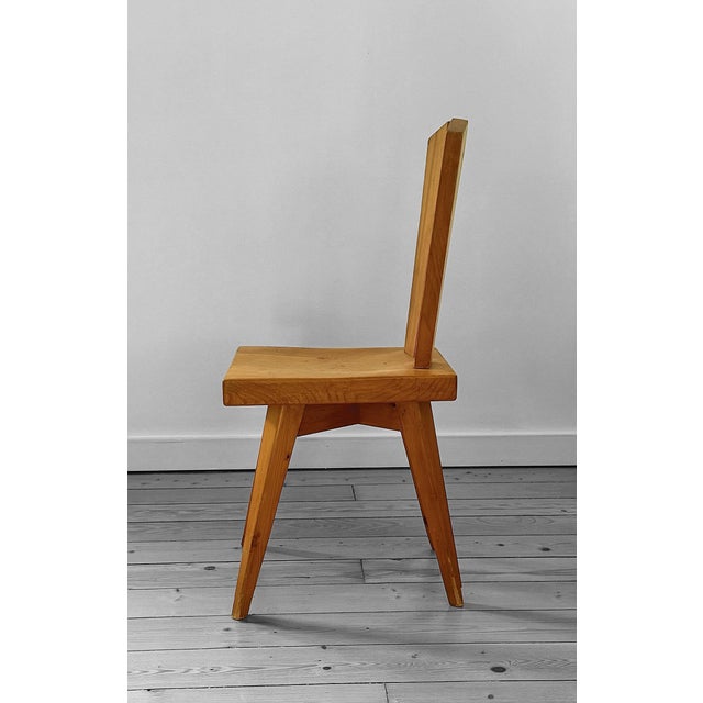 Dining chair in pine wood, a timeless masterpiece born from the collaboration between Christian Durupt and Charlotte...