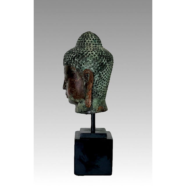 An eye catching image of Buddha mounted on a high quality black square pedestal. Identified as a depiction of Bodhisattva...