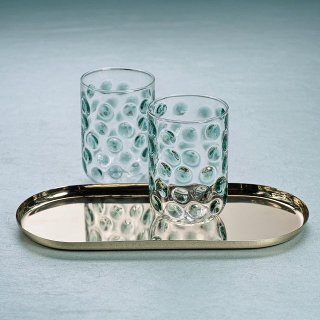 A fresh twist on everyday glassware, this borosilicate tumbler catches the light with its softly dimpled texture and airy,...