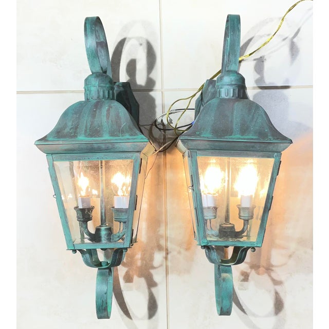 Elegant pair of solid brass wall lanterns. featuring a timeless French Quarter-inspired design. The lanterns feature a...