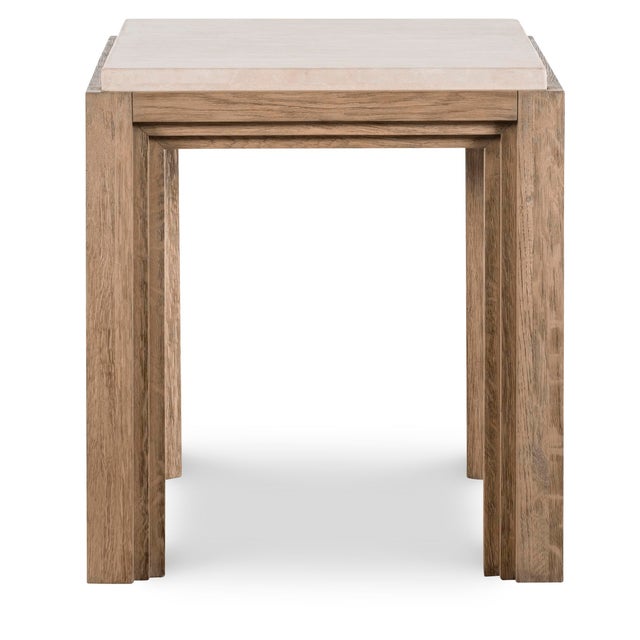 A refined square side table that pairing warm oak with a pale travertine top. This two-tone piece features substantial,...