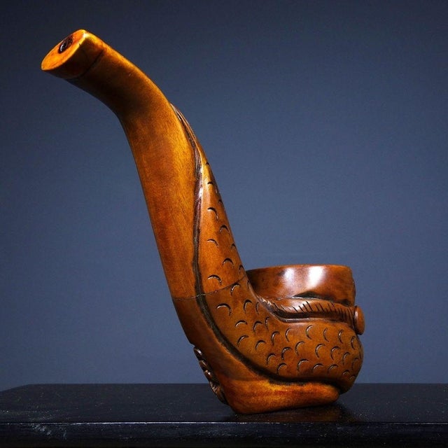 This is a finely carved antique rosewood tobacco pipe, featuring a bold, deep-relief dragon motif. The bowl is shaped into...