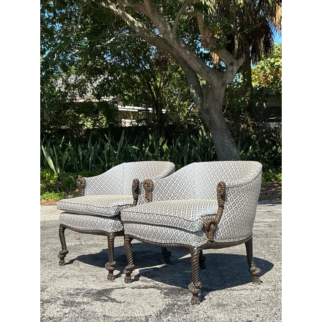 This pair of vintage Regency rope and knot lounge chairs offers a striking blend of whimsy and refinement. The intricately...
