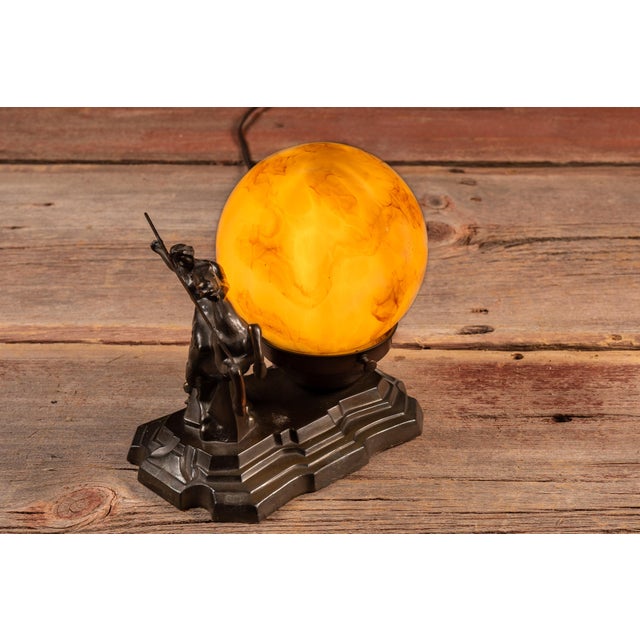 Striking Art Deco figural table lamp depicting a nude female rider mounted on a rearing horse, spear extended in a...