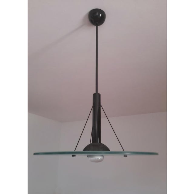 This refined mid-century modern pendant lamp, a leading European manufacturer renowned for its high-quality modernist...