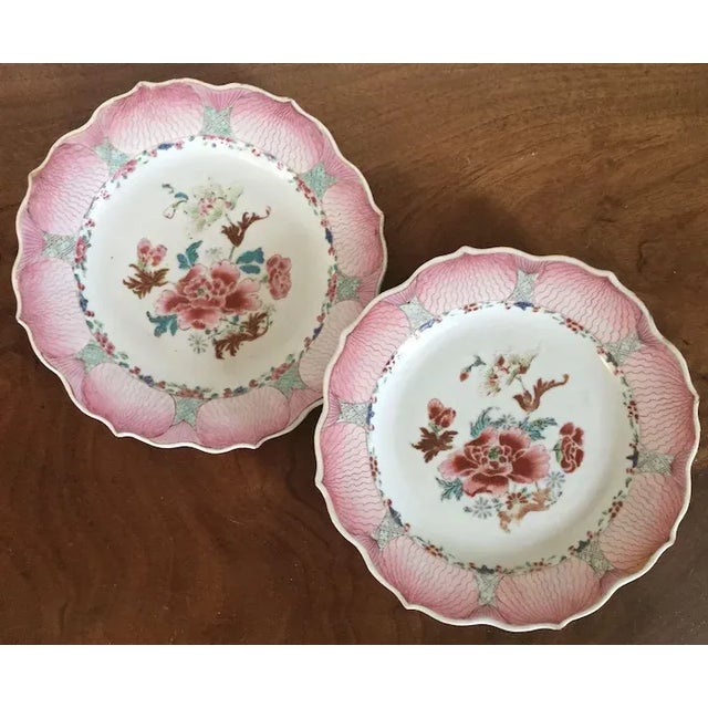 Antique pair 18th century Chinese export porcelain famille rose plates decorated with peonies within a shaped lotus border...