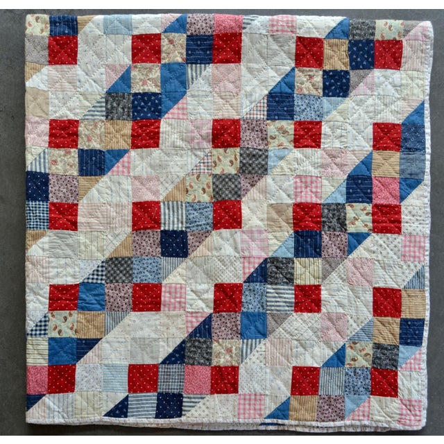 Found in New Hampshire. This mid-weight quilt is hand-stitched and hand-quilted in beautiful squares of small prints,...