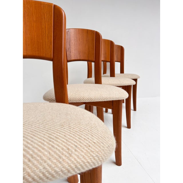 A striking set of mid-century Danish design! This high-quality set of 4 solid wood chairs was designed by Gramrode...