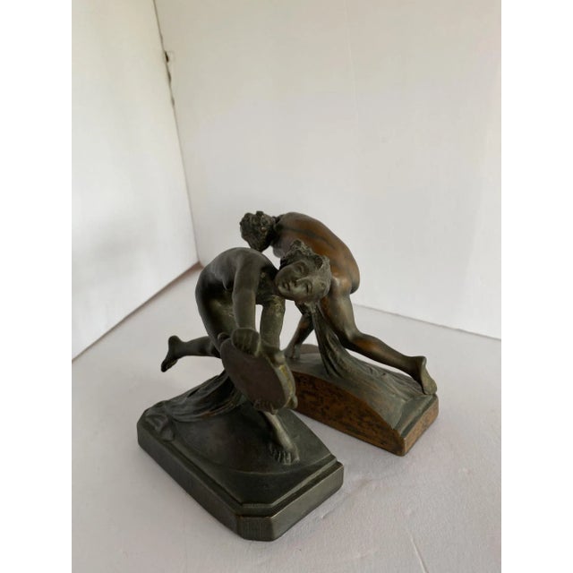Turn of the century Art Nouveau Nude Female Nymph bronze bookend pair featuring young nymphs each holding a tambourine....