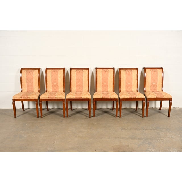 A gorgeous set of six Regency or Neoclassical style dining chairs In the manner of Baker Furniture USA, Circa 1980s Carved...