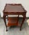 A hand carved, two tiered, square side table made from nicely carved mahogany in Chippendale style. The table features a...
