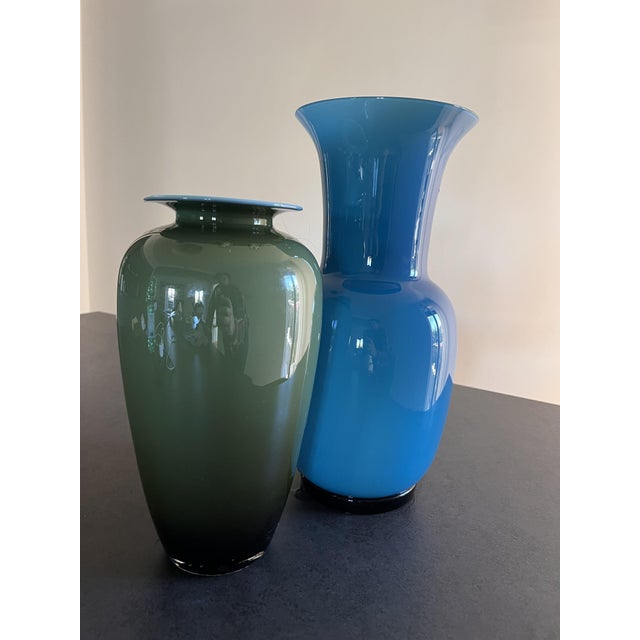 A cased opaline glass vase with a ridged base; the base bears the brand and year: "Venini 1992." The vase is in perfect...