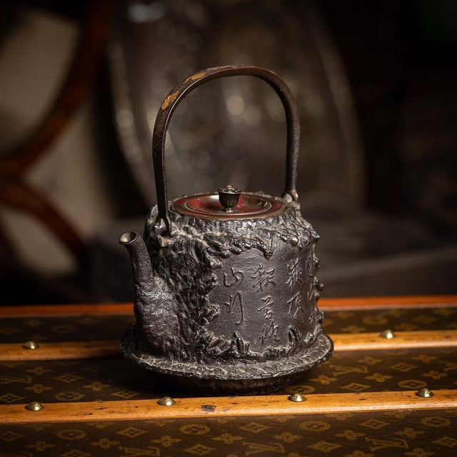 Antique 19th Century Japanese cast iron Seiryudoa carved tetsubin kettle. The cylindrical iron body is cast to resemble a...