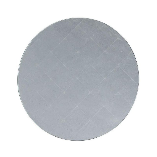 A lovely 18th Century French inspired gueridon with an inset silver leaf glass top over curvaceious metal legs that are...