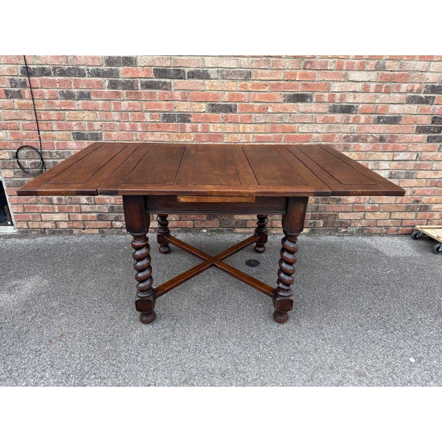 This is a great little English game table/draw leaf table measures 60' with both leafs extended. The wood is dark oak the...