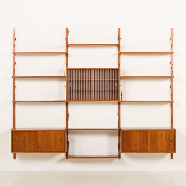 This elegant mid-century wall unit closely resembles poul cadovius and preben sorensen designs and was made in denmark in...