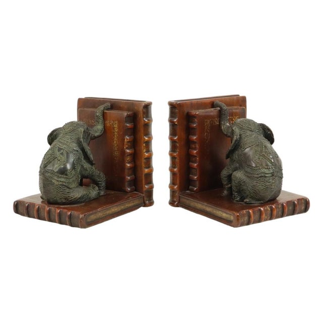 A fine pair of heavy, handmade asian-style bookends; the elephants are crafted from patinated bronze, the book elements...