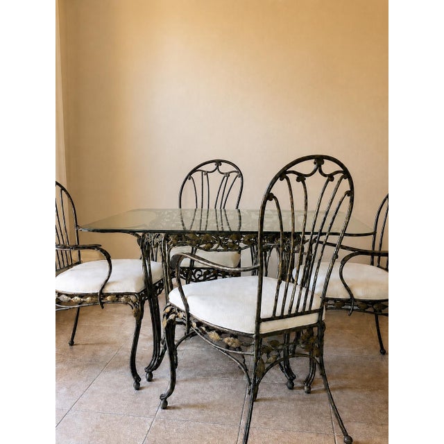 Stunning vintage wrought iron dining collection by Hooker Furniture featuring an elegant hand-forged vine and leaf motif...