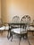 Stunning vintage wrought iron dining collection by Hooker Furniture featuring an elegant hand-forged vine and leaf motif...