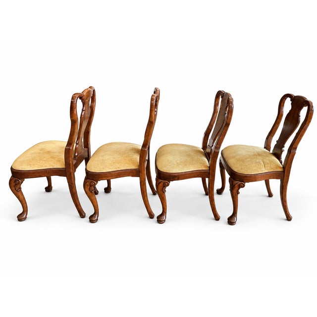 Elegant set of four vintage Queen Anne style dining chairs featuring beautifully figured burl wood splats, graceful curved...