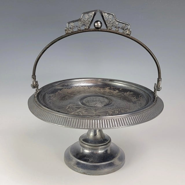 This antique Pairpoint Mfg. quadruple silver plated pedestal fruit compote or bride's basket has an intricate aesthetic...