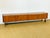 A vintage low sideboard with a clean design, emblematic of the scandinavian modernist style of the 1960s. made of teak...