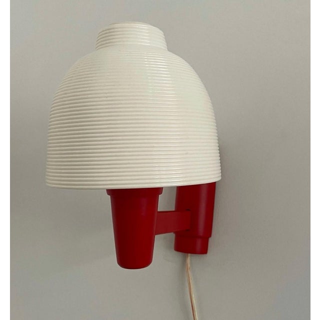Lovely, small, mid-century modern wall lamp. Designed by Yasha Heifetz for Rotaflex Heifetz, 1960s, USA. Its shade is made...