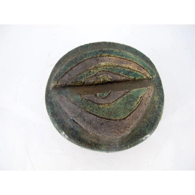 Denmark studio pottery artist, Ulla Sutton, box with lid. Iridescent green with eye decoration at top of lid. Signed at...