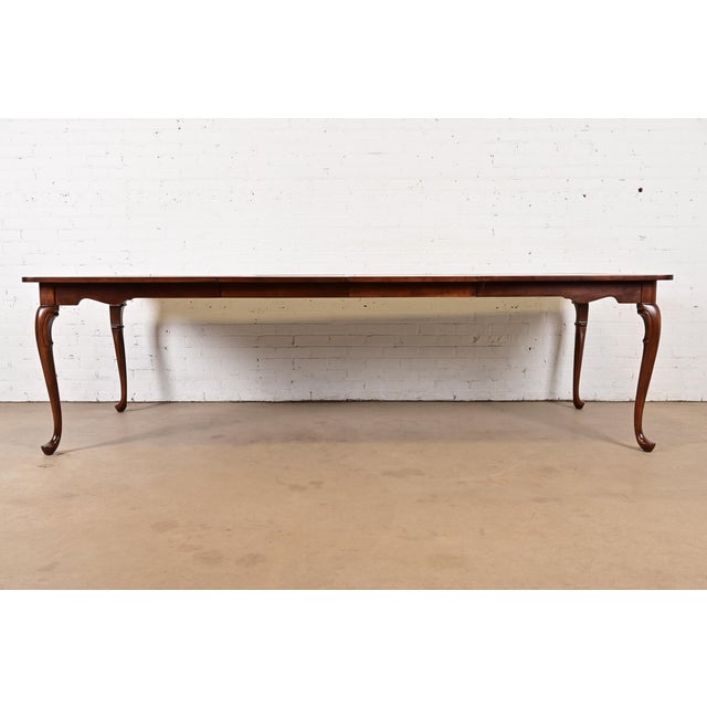 An exceptional Queen Anne or Georgian style solid cherry wood parquet top extension dining table By Harden Furniture USA,...
