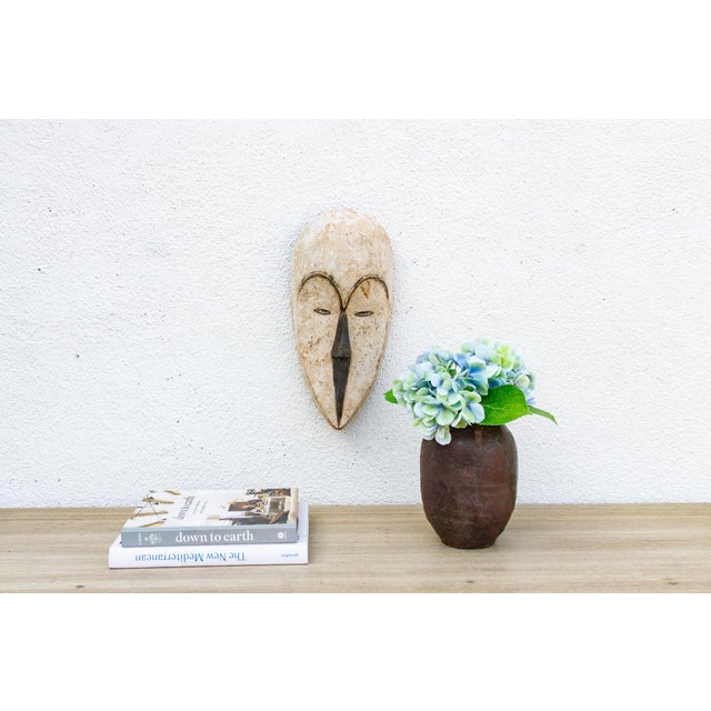 This captivating Baule mask from the Ivory Coast is a beautiful example of African tribal art. The mask is characterized...