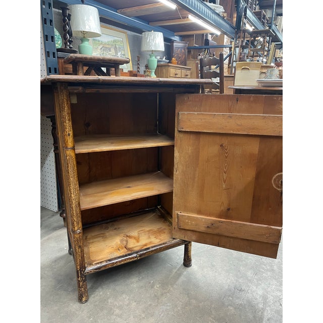 Antique Bamboo Cabinet with 3 shelf interior. Great for bedside, small hallway or bathroom. New Rattan covering. Found in...