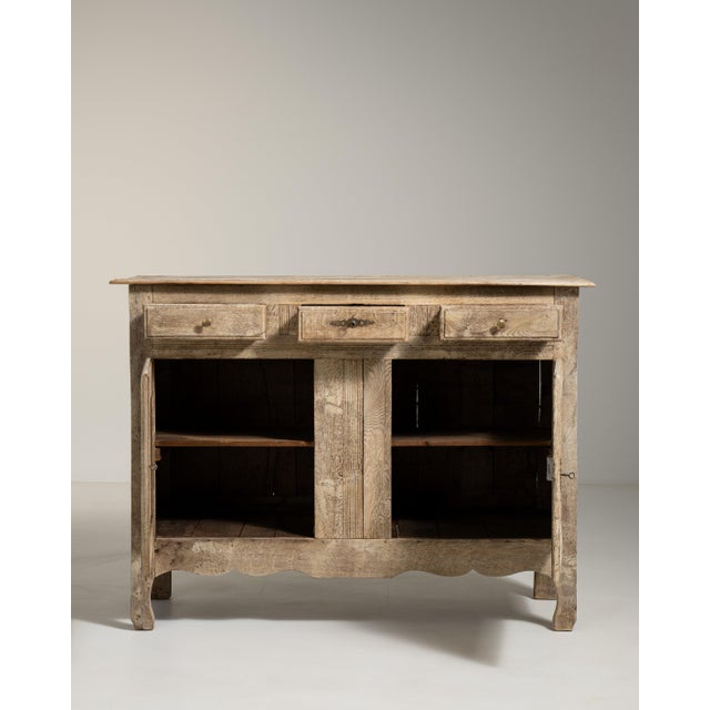 A solid oak buffet reflecting traditional French craftsmanship, with a strong emphasis on durability and practical...