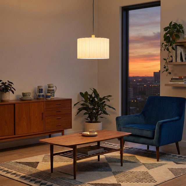 The scallop pleated shade with walnut wood and weathered brass accents makes for an ideal ceiling pendant lamp. It is both...