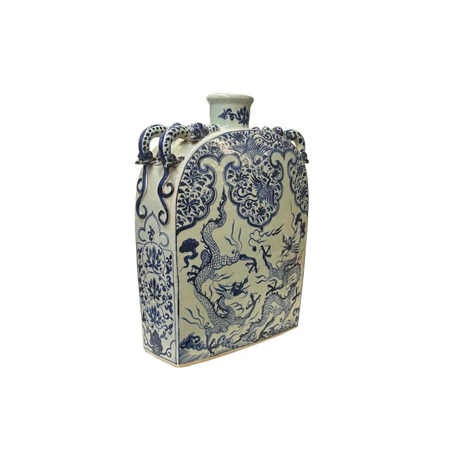 This oriental flat porcelain vase is a striking example of traditional Chinese ceramic artistry, characterized by its...