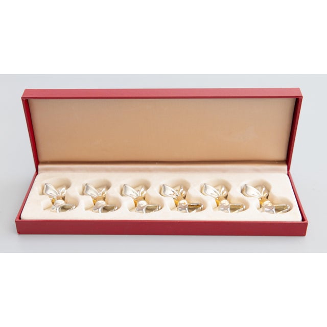 A lovely vintage boxed set of six silver and gold tone metal bows place card holders, from Paris, France. No maker's mark....