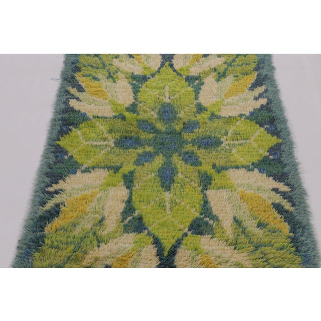 Hand-knotted in lush, high-pile wool in Sweden circa 1960-1970, this 3x5 vintage Swedish Rya rug is a bold new addition to...