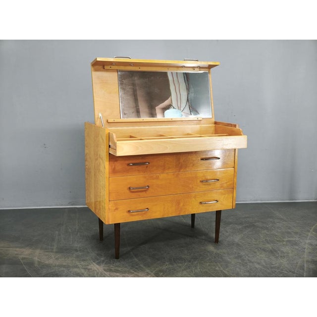 Elegant Mid-Century Modern vanity chest manufactured by UP Zavody in Czechoslovakia during the 1970s. Crafted from solid...