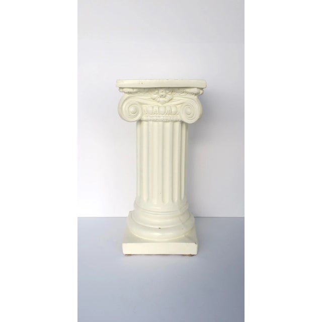 A Neoclassical style plaster glazed column pedestal with fluted pillar in the Ionic order style, circa mid to late-20th...