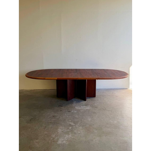 Stunning Danish Mid-Century Modern extendable dining table produced by Ansager Møbler, crafted in richly figured rosewood....