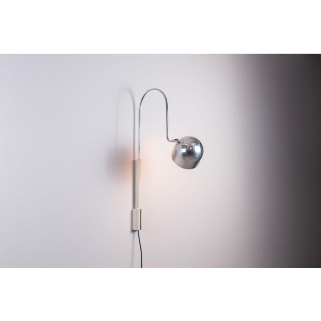 This elegant adjustable wall lamp, designed by Danilo and Corrado Aroldi and produced by Stilnovo, exemplifies the...