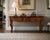 An impressive vintage console table by Mastercraft Furniture Co. of Grand Rapids, Michigan, combining richly figured burl...