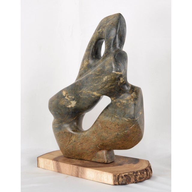 Organic abstract sculpture by G. Krueger. The Serpentine stone has gorgeous earth-toned green, yellow, and orange hues,...