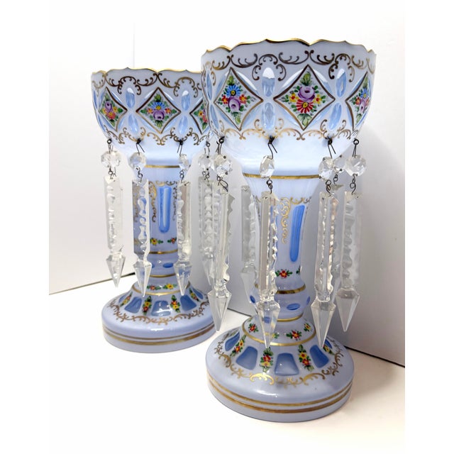This Antique Bohemian Czech Victorian Blue Opaline Glass Enamel Floral Lusters Pair features two identical 11.75 inch tall...
